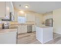Kitchen with white cabinets, stainless steel appliances and island at 195 Fox Squirrel Run, Summerville, SC 29483