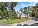 Gray sided home with black shutters and a large driveway at 2340 Marsh Hen Dr, Seabrook Island, SC 29455