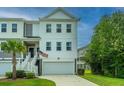 Two-story townhome with attached garage and American flag at 210 Winding River Dr, Johns Island, SC 29455