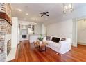 Open living area featuring hardwood floors, a cozy fireplace and a white couch at 35 Society St # A, Charleston, SC 29401