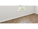 Simple bedroom with wood-look flooring and large window at 168 River Hill Rd, Goose Creek, SC 29445