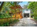 Two-story home with wrap-around porch and golf cart garage at 412 E Hudson Ave, Folly Beach, SC 29439