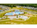 Aerial view of community pool, playground, and surrounding homes at 530 Golden Embers Way, Summerville, SC 29486