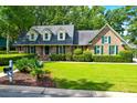 Brick home with green shutters and landscaped yard at 10 Trail Hollow Dr, Charleston, SC 29414