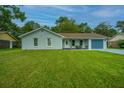 Newly renovated light gray house with a lush green lawn at 133 Marion Rd, Summerville, SC 29486