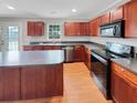 Modern kitchen with dark wood cabinets and black appliances at 119 Mockernut Dr, Ladson, SC 29456