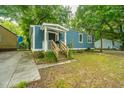 Blue house with a wooden porch and a grassy yard at 2355 Cambridge Ave, North Charleston, SC 29405