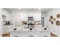 Spacious kitchen featuring white cabinets, granite countertops, and an island at 5528 Bowmore Blvd, Ravenel, SC 29470
