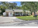 Brick ranch home with green shutters, attached garage, and lawn at 117 Wessex Dr, Goose Creek, SC 29445