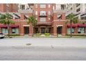 Brick building entrance with palm trees and awnings at 150 Bee Street # 614, Charleston, SC 29401