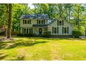 Two-story home with gray siding, large windows, and a welcoming porch at 107 Tryon Dr, Summerville, SC 29485