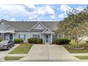 Grey house with blue shutters and landscaped yard at 161 Townsend Way, Summerville, SC 29483