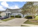 Grey house with blue shutters and landscaped yard at 161 Townsend Way, Summerville, SC 29483