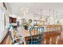 Bright dining area with large farmhouse table and hardwood floors at 3006 Cameron Blvd, Isle of Palms, SC 29451