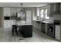 Modern kitchen with white cabinets, a large island, and stainless steel appliances at 928 Tiger Loop, Saint Stephen, SC 29479