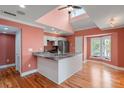 Open kitchen with granite countertops, stainless steel appliances, and hardwood floors at 1616 Live Oak Park, Seabrook Island, SC 29455