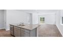 Kitchen island with granite countertop, double sink, and stainless steel appliances at 369 Willows Crescent Dr, Moncks Corner, SC 29461