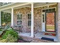 Brick front porch with white columns and bench at 7002 Sassafrass Ct, Summerville, SC 29485