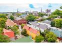 Aerial view of a neighborhood with colorful houses and a city skyline at 167 Coming St, Charleston, SC 29403