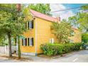 Yellow house with black shutters and red roof at 167 Coming St, Charleston, SC 29403