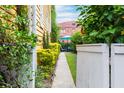 Pathway through a lush green side yard at 167 Coming St, Charleston, SC 29403