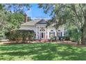 White house with a large front porch, columns, and lush landscaping at 3427 Colonel Vanderhorst Cir, Mount Pleasant, SC 29466