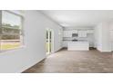 Open concept kitchen with white cabinets, granite countertops and island at 361 Willows Crescent Dr, Moncks Corner, SC 29461