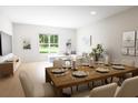 Open concept dining room with wooden table and kitchen view at 7411 Indigo Palms Way, Johns Island, SC 29455