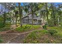Spacious backyard with lush landscaping and a winding pathway at 589 Oyster Rake Dr, Kiawah Island, SC 29455