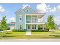 Two-story light blue house with a wrap-around porch and white columns at 112 Archdale St St, Summerville, SC 29486