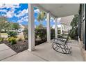Covered front porch with rocking chairs and neighborhood view at 462 Eastern Isle Ave, Summerville, SC 29486