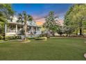 Two-story home with metal roof, porch, and landscaped yard at 705 S Magnolia St, Summerville, SC 29483