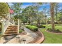 Attractive home exterior with well-manicured lawn, brick walkway, and lush landscaping at 705 S Magnolia St, Summerville, SC 29483