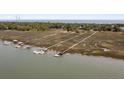 Aerial view of waterfront property with private docks and marsh views at 218 E Huron Ave, Folly Beach, SC 29439