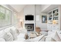 Cozy living room with white slipcovered furniture and a fireplace at 933 Mccants Dr, Mount Pleasant, SC 29464