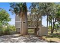 Two-story home with a screened porch and lush landscaping at 2473 High Hammock Rd, Seabrook Island, SC 29455