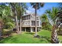 Elevated home nestled among trees, screened porch at 2473 High Hammock Rd, Seabrook Island, SC 29455