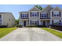 Tan two-story home with dark shutters and landscaping at 2429 Scholar Ln, North Charleston, SC 29406