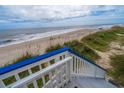 Beach access staircase leading to sandy beach and ocean views at 144 Palmetto Blvd, Edisto Island, SC 29438