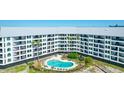 Aerial view of building showcasing a kidney-shaped pool and beachfront location at 9002 Palmetto Dr # 512, Isle of Palms, SC 29451