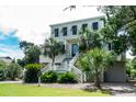 Two story beach home with a large front porch and attached garage at 3002 Palmetto Blvd # 6, Edisto Beach, SC 29438