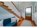 Bright entryway with hardwood floors, a staircase, and a blue bench at 3002 Palmetto Blvd # 6, Edisto Beach, SC 29438