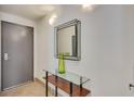 Bright entryway with a sleek mirror and glass-top console table at 487 King St # 202 Penthouse, Charleston, SC 29403
