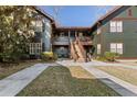 Two-story building exterior with green siding and wooden staircase at 5559 Colonial Chatsworth Cir, North Charleston, SC 29418