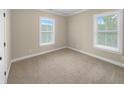 Bright bedroom with neutral colored carpet and two windows at 3699 Shutesbury St, Mount Pleasant, SC 29466