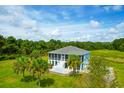 Aerial view of a single-Gathering home with large screened porch and lush landscaping at 3238 Plow Ground Rd, Johns Island, SC 29455