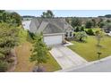 Aerial view of a tan house with a large yard and a lake nearby at 586 Eastern Isle Ave, Summerville, SC 29486