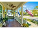 Inviting front porch with a swing, American and South Carolina flags at 415 Watergrass Way, Summerville, SC 29485