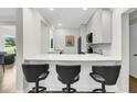 Modern kitchen with white cabinets, quartz countertop, and breakfast bar at 4910 Green Dolphin Way, Kiawah Island, SC 29455