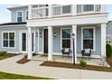 Front porch with two chairs and exterior lighting at 15 Tidewater Ln, Summerville, SC 29486